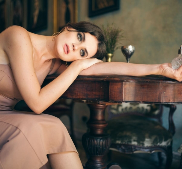 attractive-seductive-sensual-stylish-woman-boho-dress-sitting-vintage-retro-cafe-holding-perfume-1